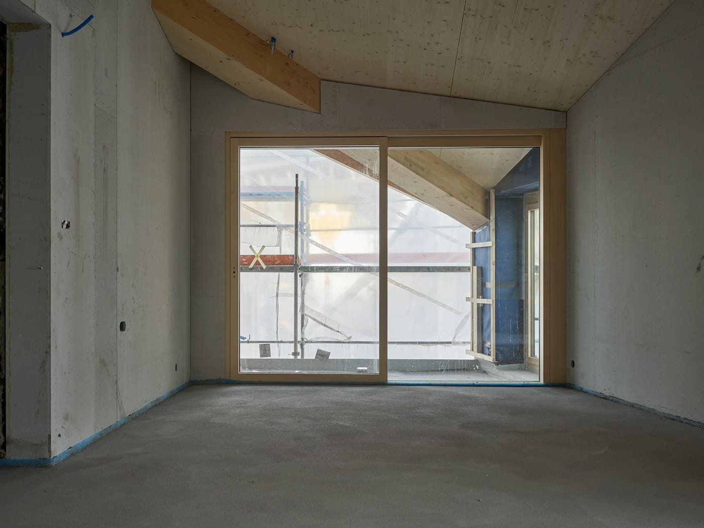Newly built interior with bare concrete floors before handover